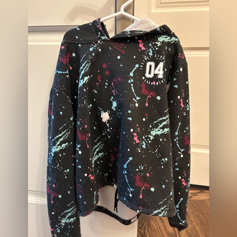 Black hoodie with splatter paint pattern from Justice